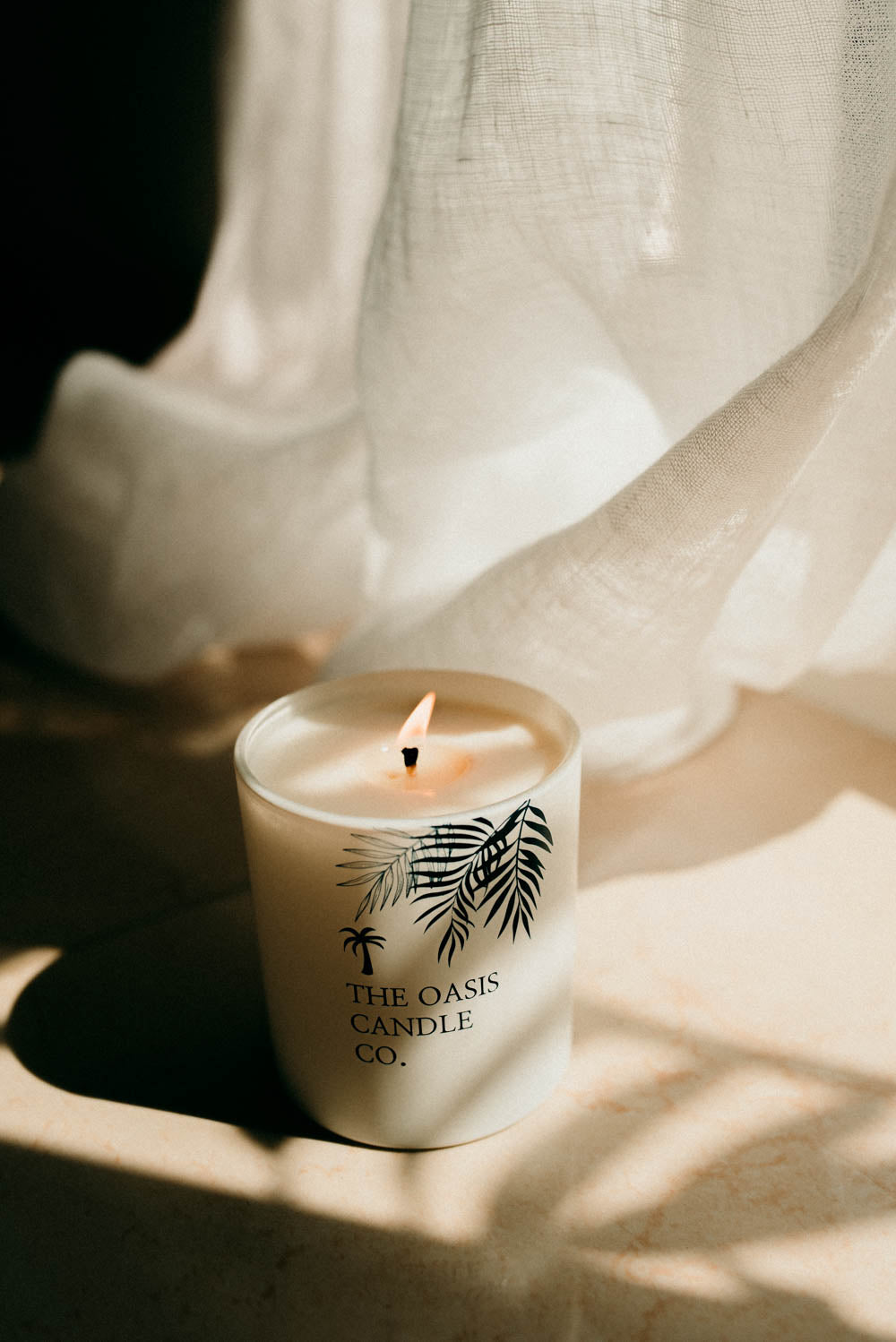 A Tonka and Myrrh scented candle from home fragrance brand, The Oasis Candle Co